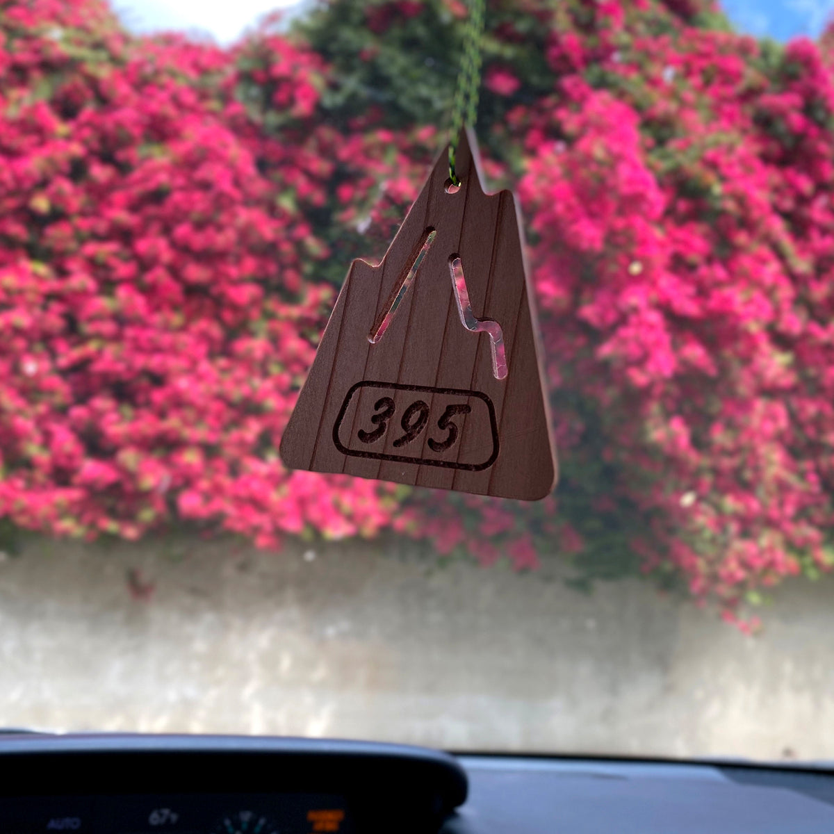 The mountain shaped S.R. Air freshener in front of blooming bougainvillea