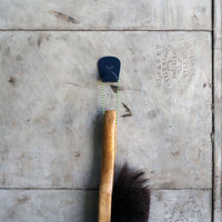 S.R. Anywhere Hook in Navy Grey on light grey metal door, holding a wood handled brush on yellow paracord.