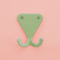 Mint Green S.R. Wall Hook on pink background.