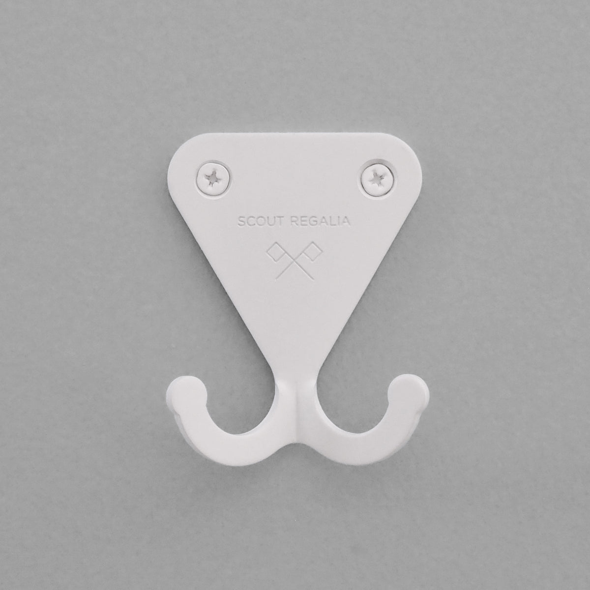 Matte white S.R. Wall Hook on a grey background.
