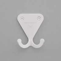 Matte white S.R. Wall Hook on a grey background.