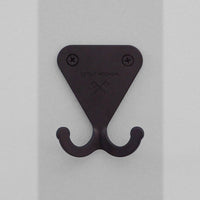 Matte Black S.R. Wall Hook on a light grey striped background.