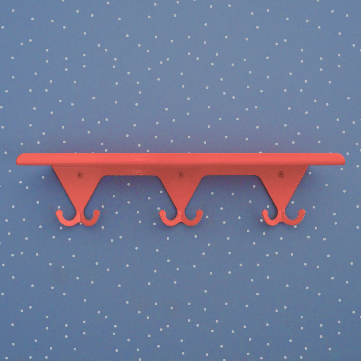 Salmon Pink S.R. Wall Rack on a light blue background with little white dots.