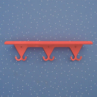 Salmon Pink S.R. Wall Rack on a light blue background with little white dots.