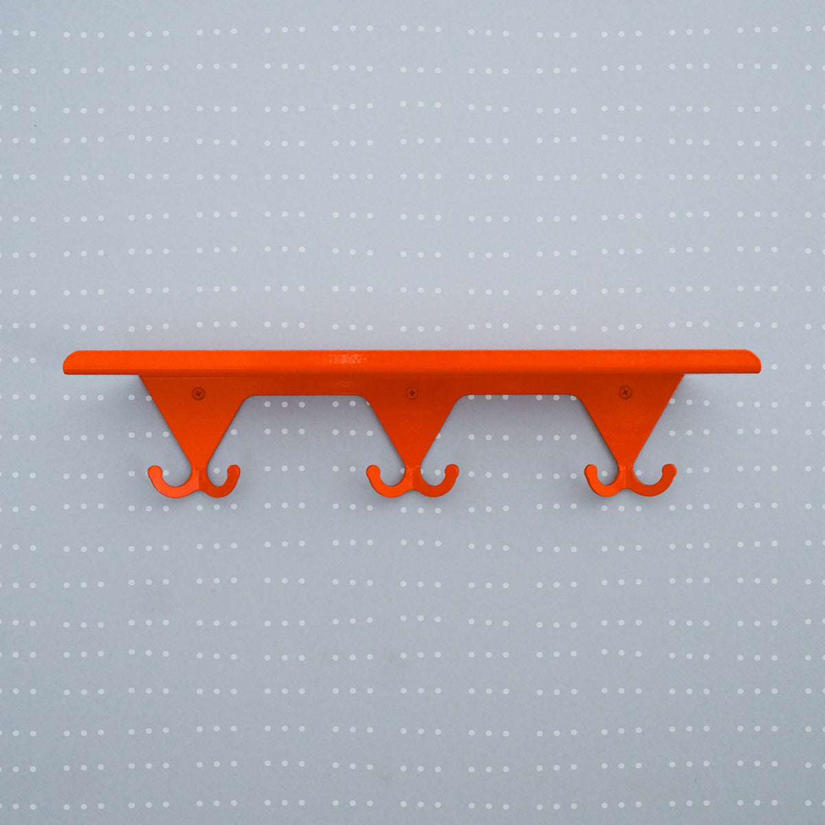 Bright Orange S.R. Wall Rack on a light grey background with white dots on a grid