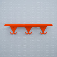 Bright Orange S.R. Wall Rack on a light grey background with white dots on a grid