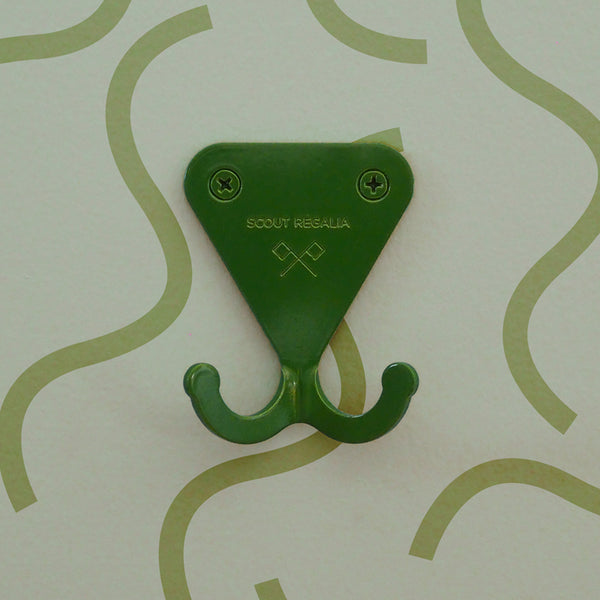 Fern Green S.R. Wall Hook on a light green background with squiggly lines