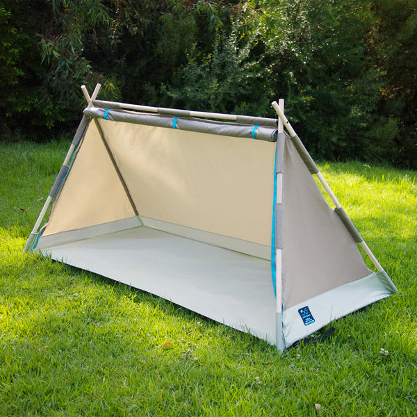 S.R. Lean To Tent on the grass with green bushes in background.