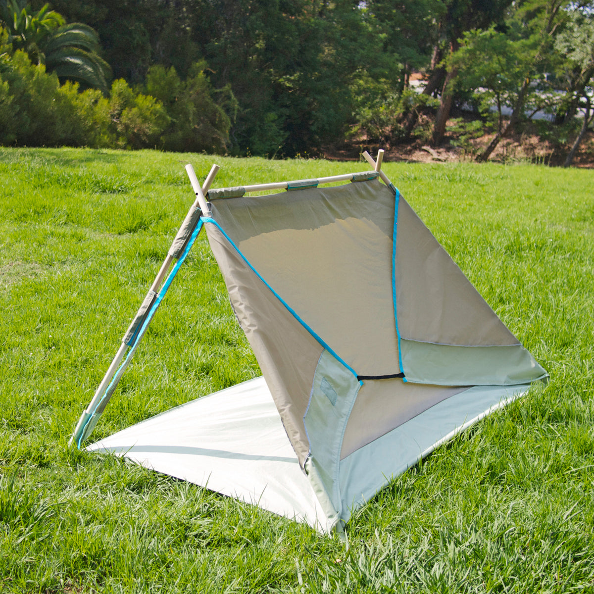 S.R. Lean To Tent Open backside view on grass with trees in background.