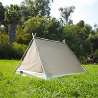 S.R. Lean To Tent Closed backside view on grass with trees in background.