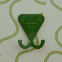 Fern Green S.R. Wall Hook on a light green background with squiggly lines.