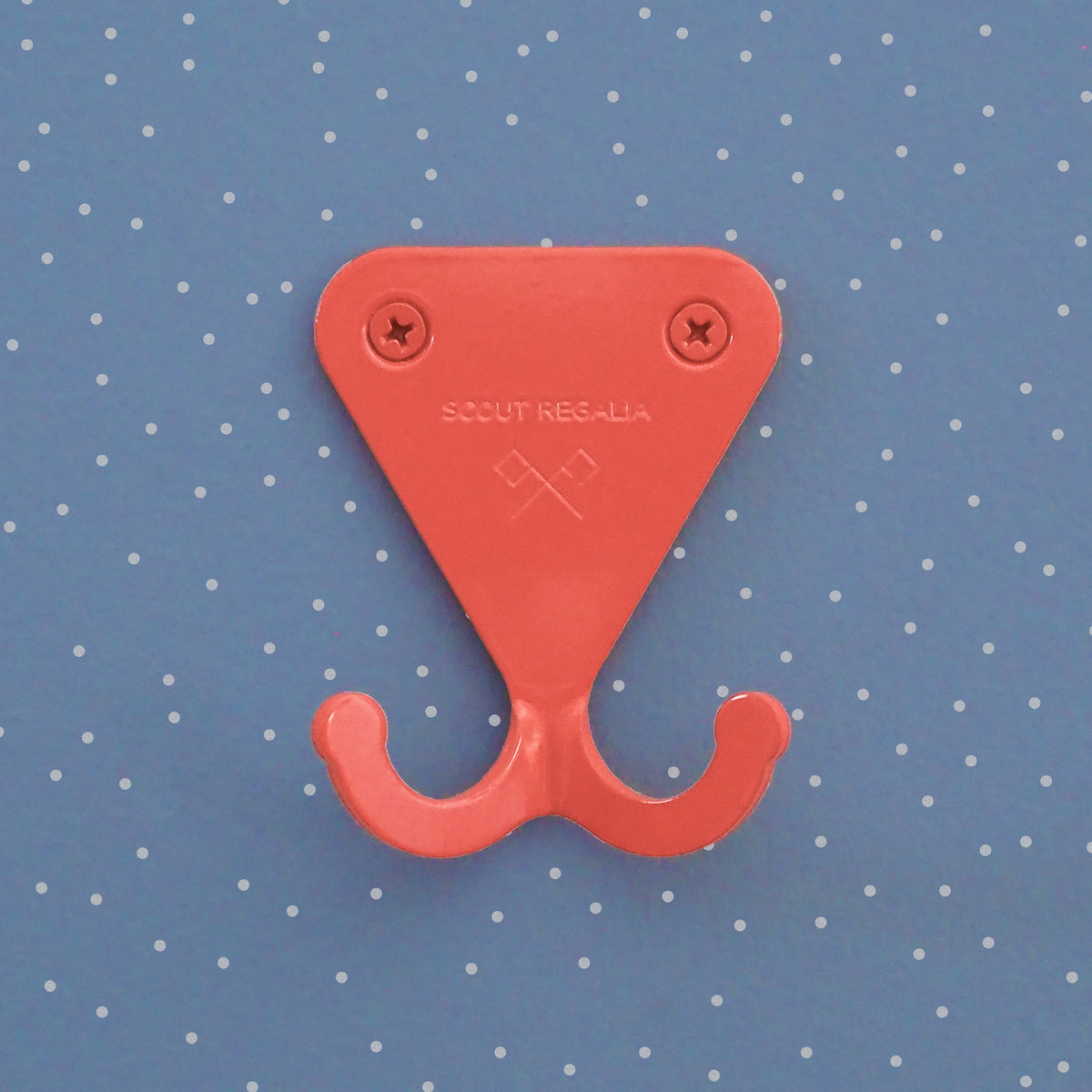 Salmon Pink S.R. Wall Hook on light blue background with dots.