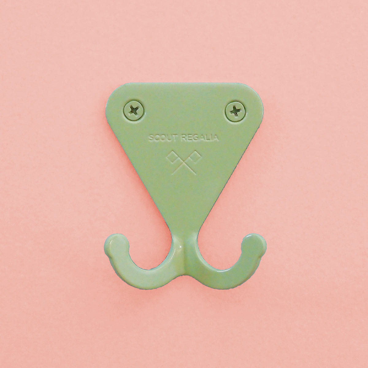 Mint Green S.R. Wall Hook on pink background.