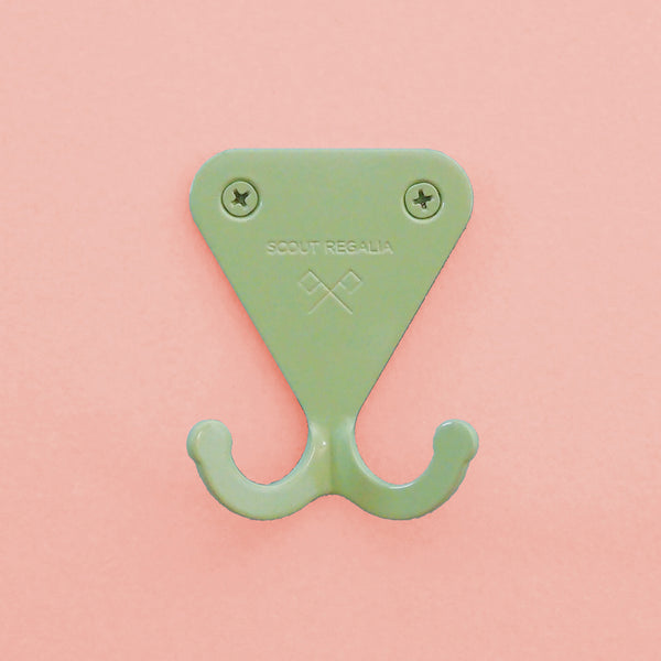 Mint Green S.R. Wall Hook on pink background.