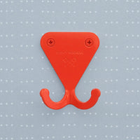 Bright Orange S.R. Wall Hook on a light grey background with dots on a grid.