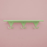 Mint Green S.R. Wall Rack on a pink background.